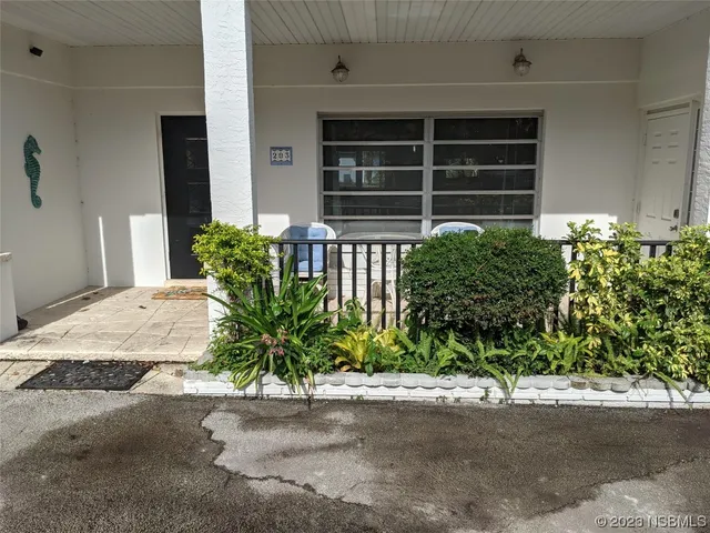 a view of a dining room with furniture window and front door