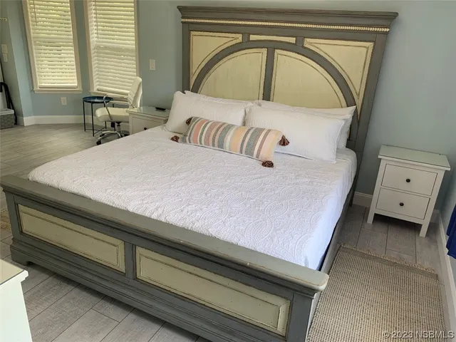 a view of a dining room with furniture and a chandelier