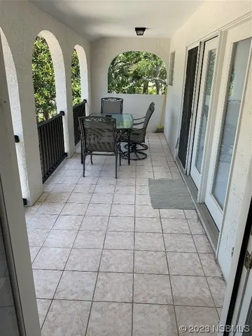 a view of balcony with wooden floor and fence