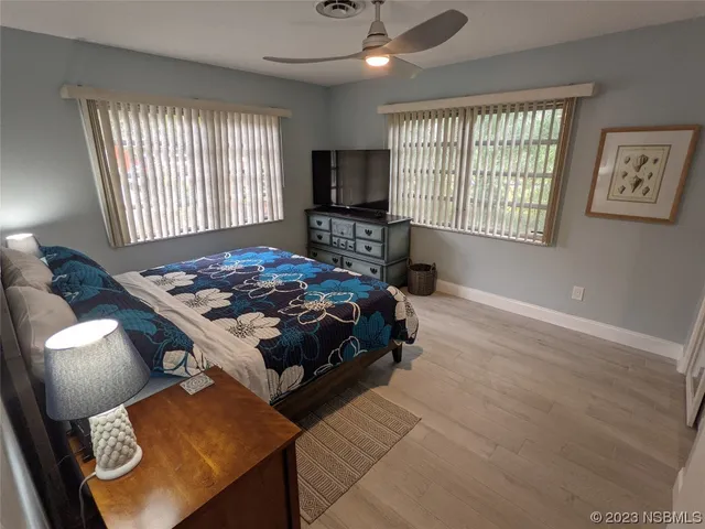 a spacious bedroom with a bed and window