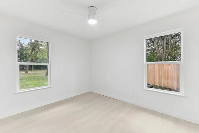 a front view of house with a garden and trees