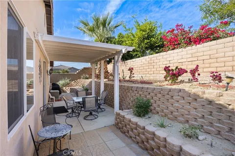 a view of a chairs and table in a patio