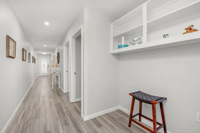 a view of a hallway with wooden floor and staircase