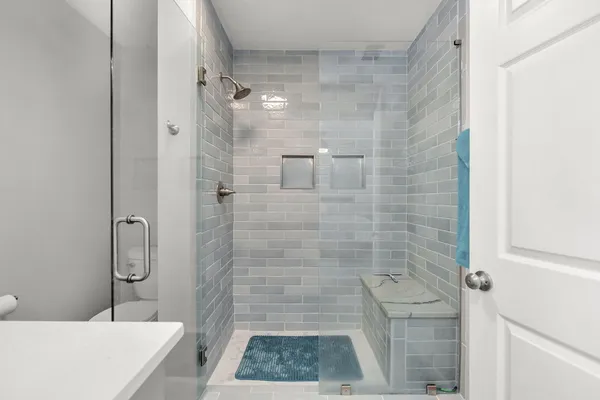 a bathroom with a granite countertop shower