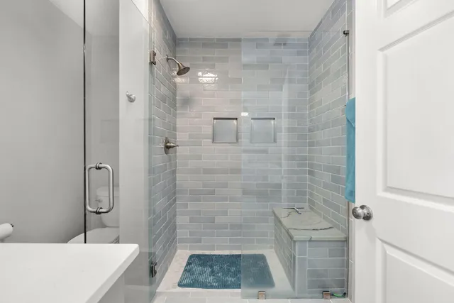 a bathroom with a granite countertop shower