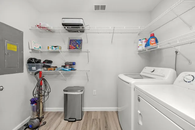 a kitchen with white cabinets sink and stove