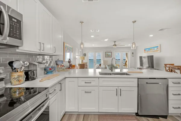 a kitchen with a sink stove and microwave