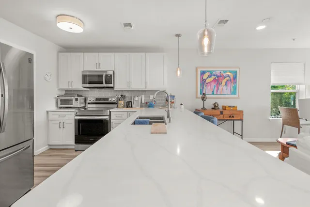 a kitchen with a refrigerator a stove a sink and a center island