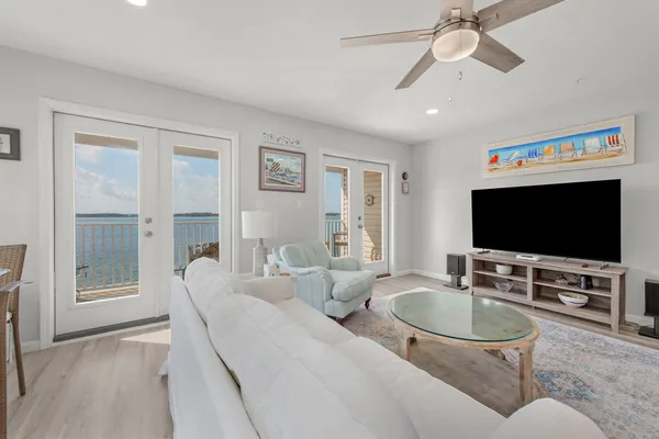 a kitchen with white cabinets and black appliances