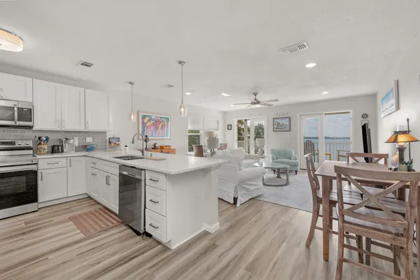 a view of a balcony with furniture and floor to ceiling window