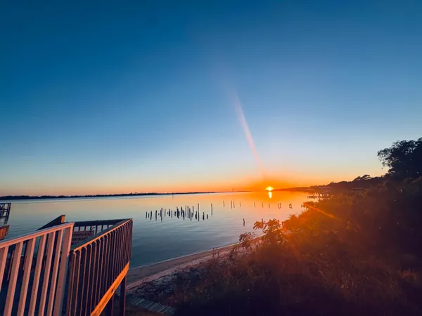 a view of roof deck with dining table and chairs