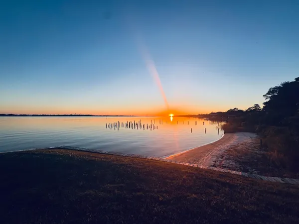 a view of roof deck with a barbeque and wooden stairs