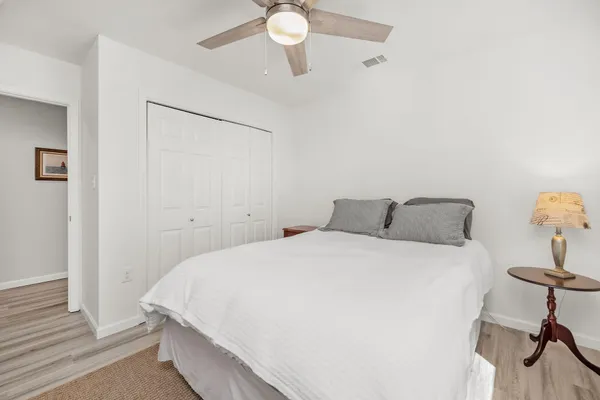 a bedroom with a bed and a chandelier