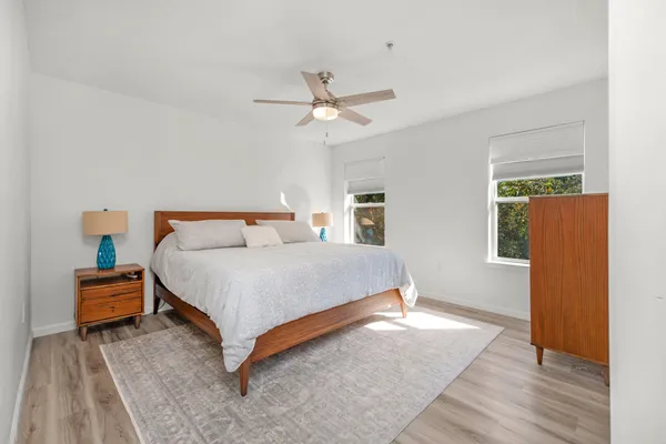 a bedroom with a bed and wooden floor