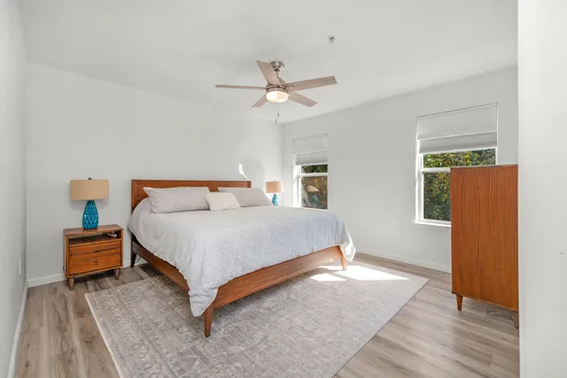 a bedroom with a bed and wooden floor