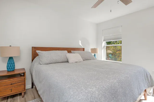 a large bed sitting in a bedroom next to a window