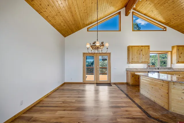 a view of a kitchen with wooden floor and electronic appliances