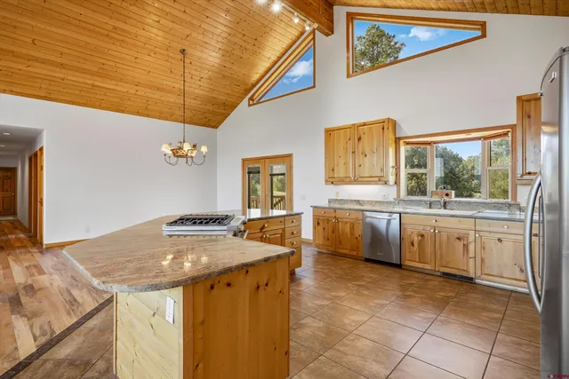 a kitchen with a stove a sink and a refrigerator