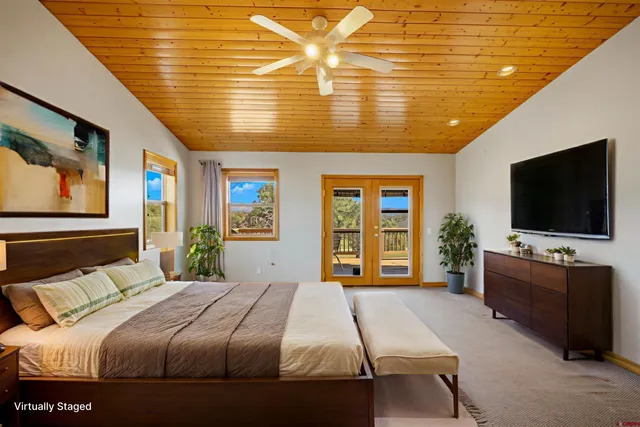 a bedroom with a bed and a flat screen tv