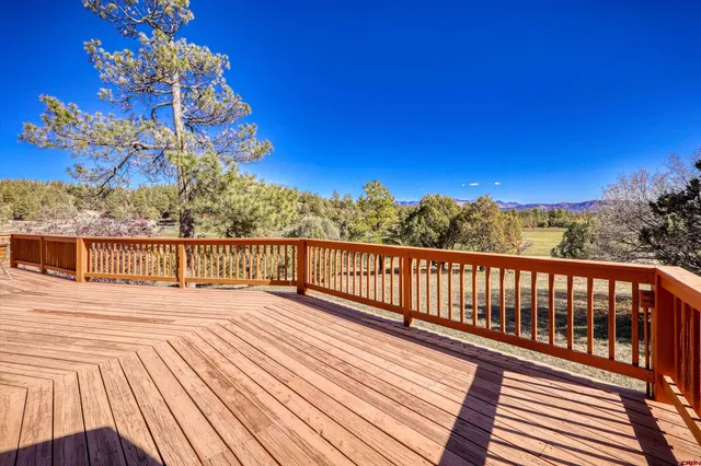a view of a balcony with wooden floor and city view