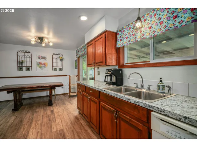 a kitchen with sink and wooden cabinets
