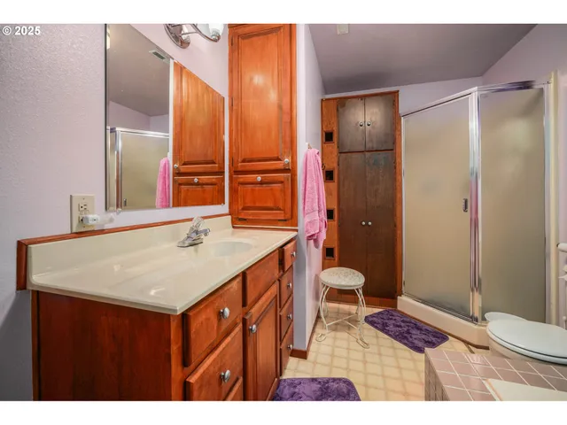 a bathroom with a sink a toilet and shower