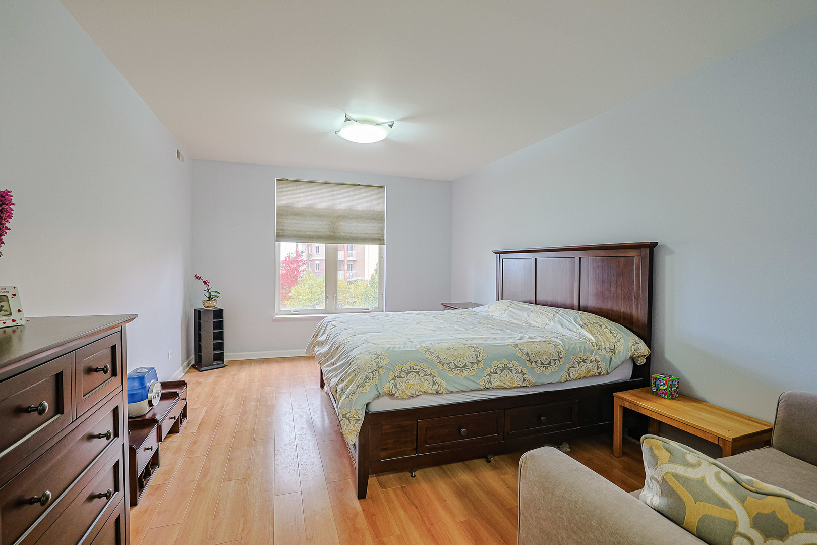 8300 Callie Avenue, Unit 311 Morton Grove, IL 60053 - Photo 11 of 21 a bed sitting in a bedroom next to a window with bookshelf