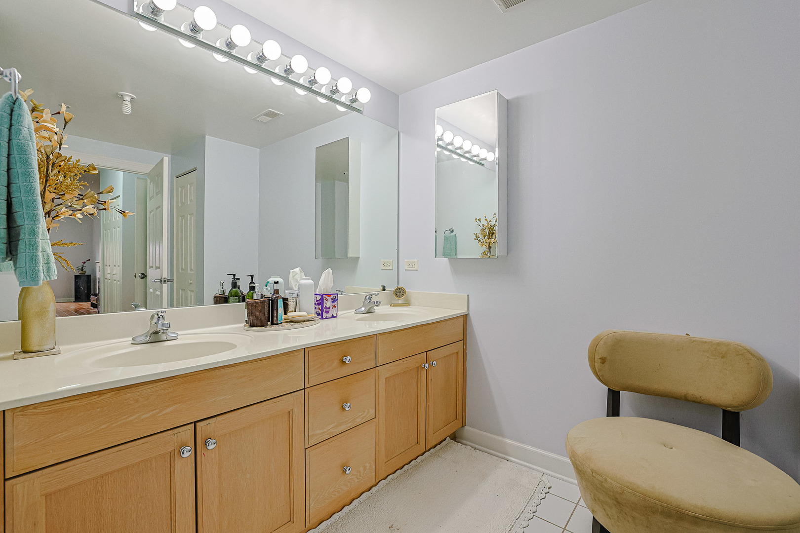 8300 Callie Avenue, Unit 311 Morton Grove, IL 60053 - Photo 14 of 21 a bathroom with a toilet sink and mirror