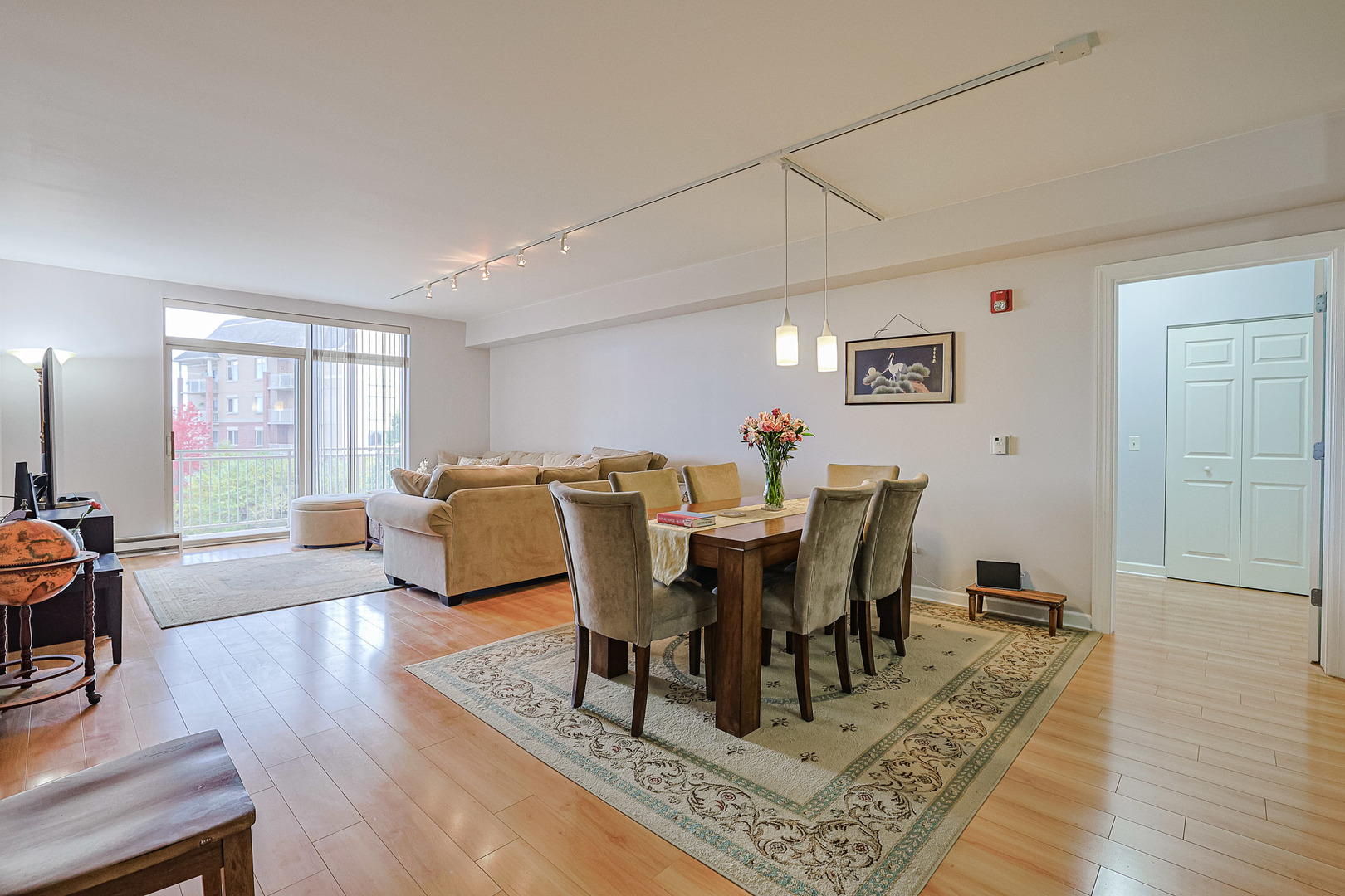 8300 Callie Avenue, Unit 311 Morton Grove, IL 60053 - Photo 4 of 21 a view of a dining room with furniture and wooden floor