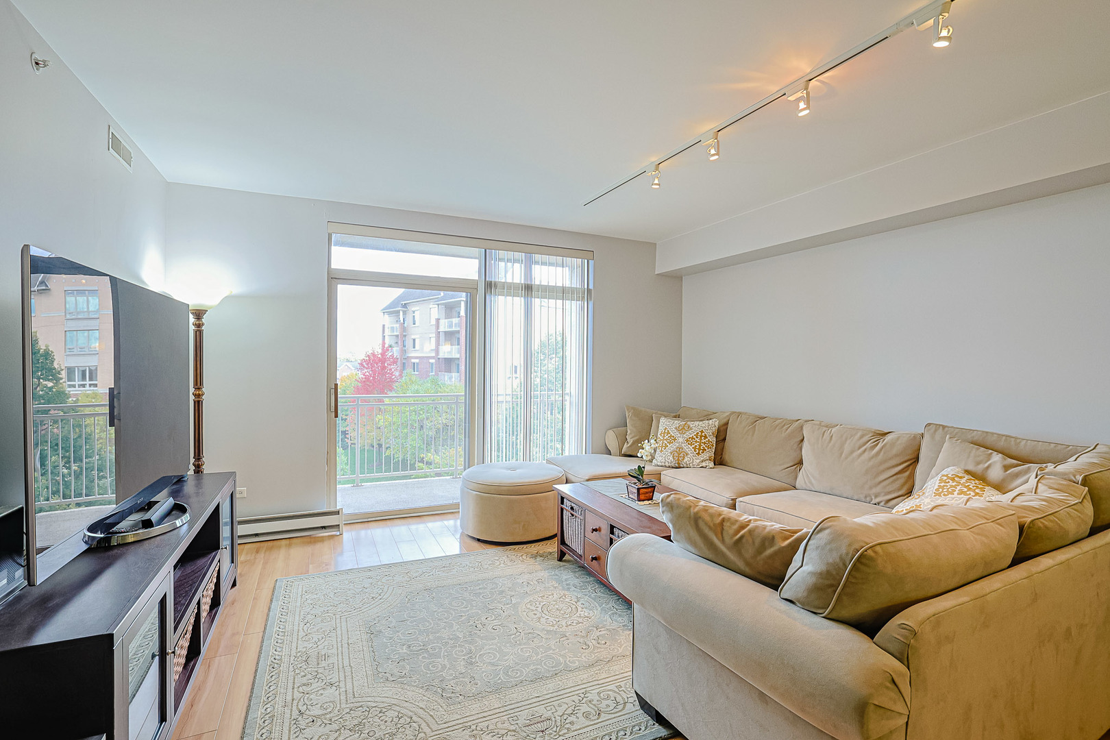 8300 Callie Avenue, Unit 311 Morton Grove, IL 60053 - Photo 5 of 21 a living room with furniture and large windows