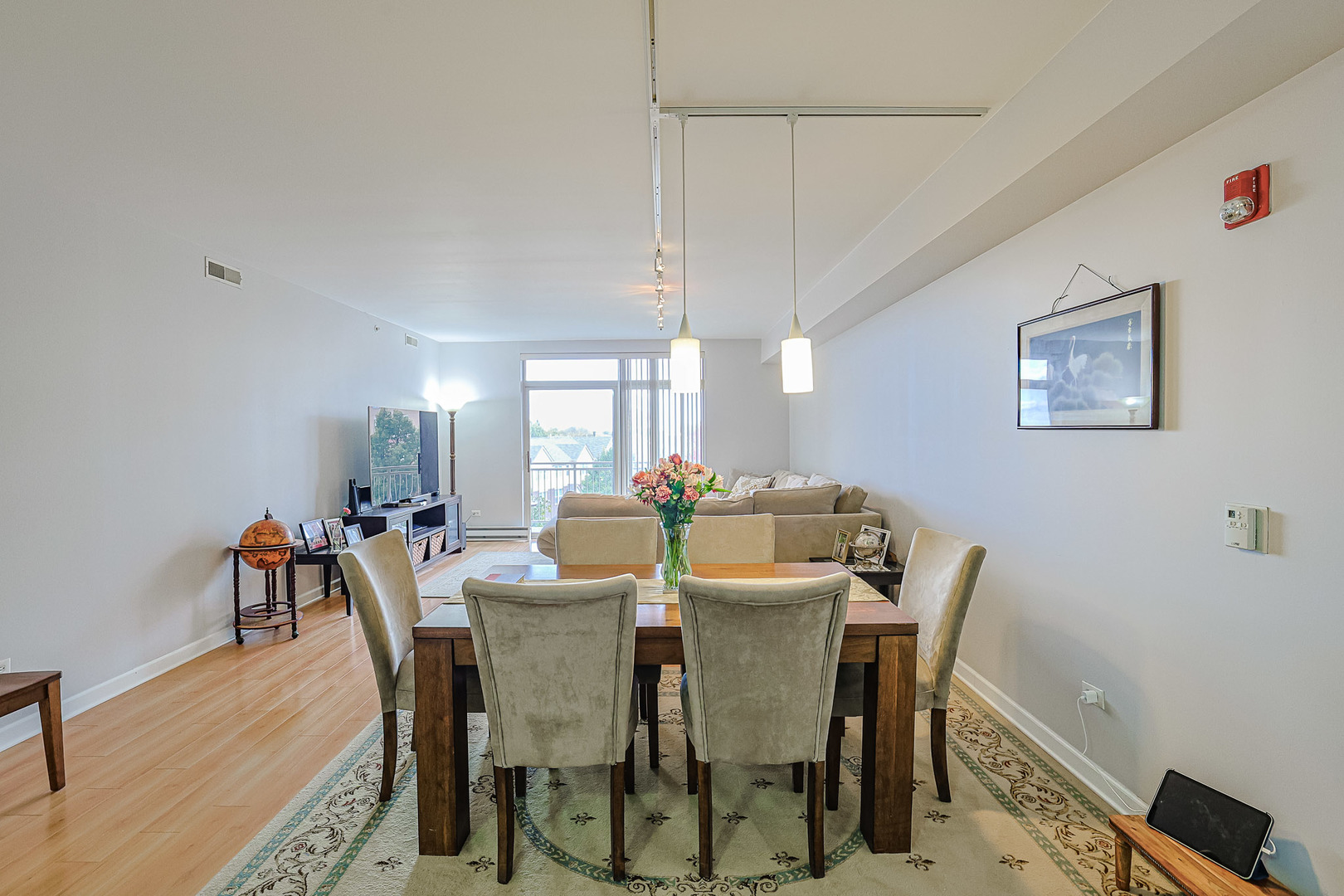 8300 Callie Avenue, Unit 311 Morton Grove, IL 60053 - Photo 6 of 21 a view of a dining room with furniture and wooden floor