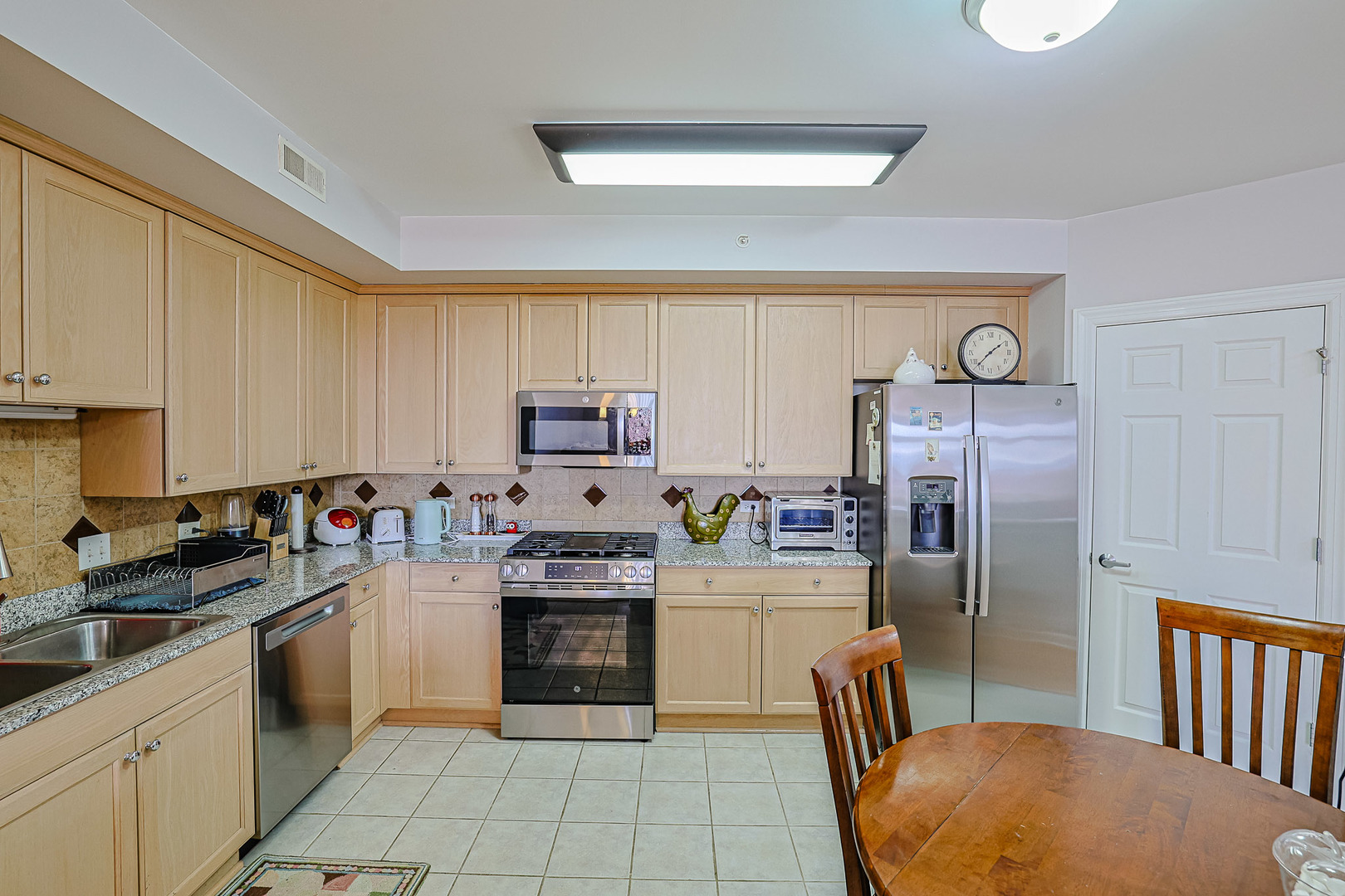 8300 Callie Avenue, Unit 311 Morton Grove, IL 60053 - Photo 9 of 21 a kitchen with stainless steel appliances a refrigerator sink and cabinets