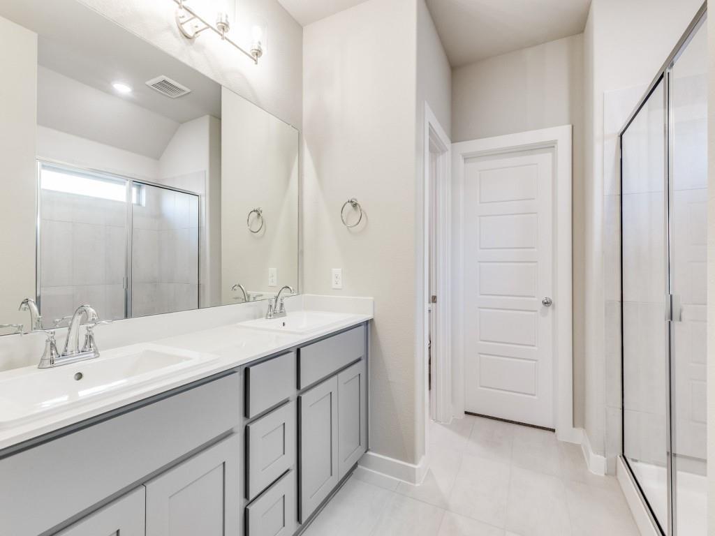 15224 Supreme Street Aledo, TX 76008 - Photo 13 of 25 a bathroom with a double vanity sink and mirror