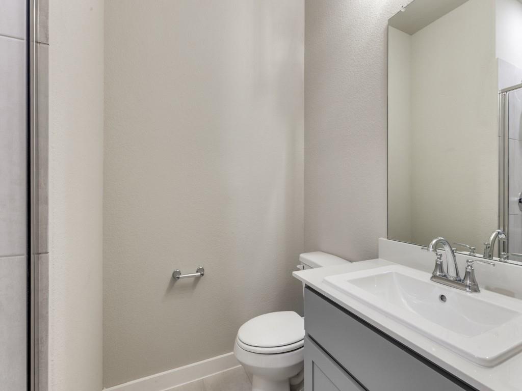 15224 Supreme Street Aledo, TX 76008 - Photo 14 of 25 a bathroom with a sink a toilet and a mirror