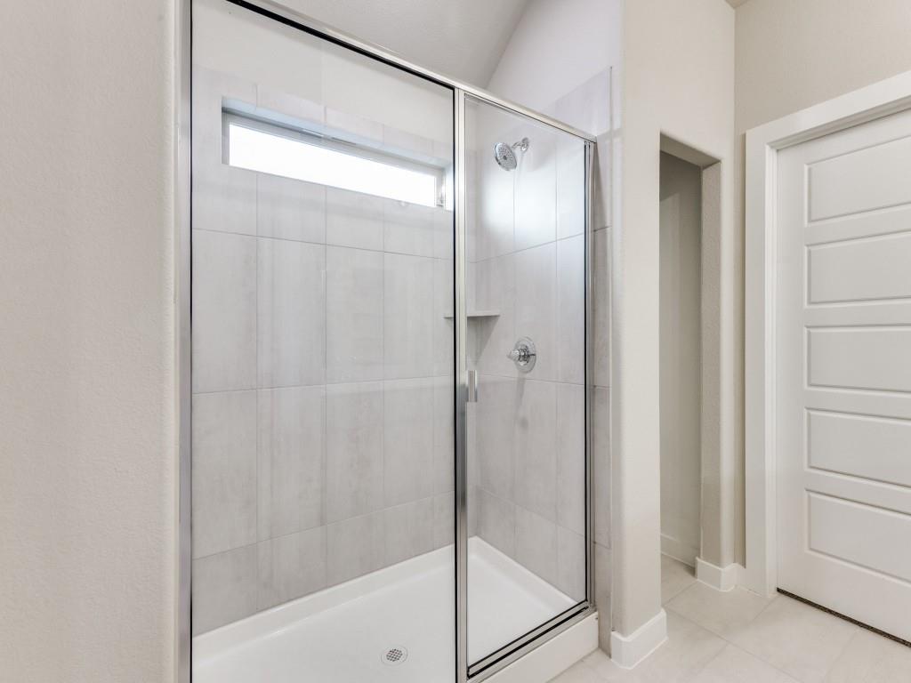 15224 Supreme Street Aledo, TX 76008 - Photo 20 of 25 a bathroom with a glass shower door