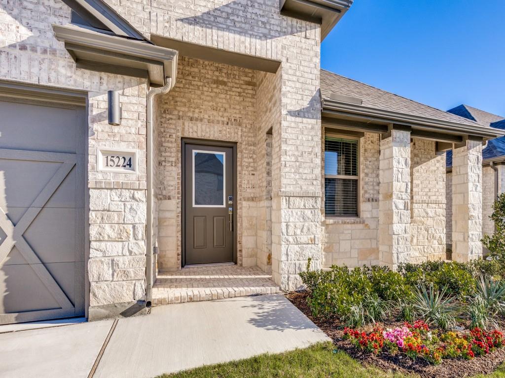 15224 Supreme Street Aledo, TX 76008 - Photo 3 of 25 a front view of a house with a garden