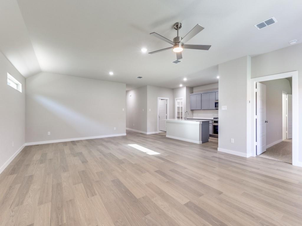 15224 Supreme Street Aledo, TX 76008 - Photo 7 of 25 a view of a kitchen with a sink and dishwasher a refrigerator with wooden floor