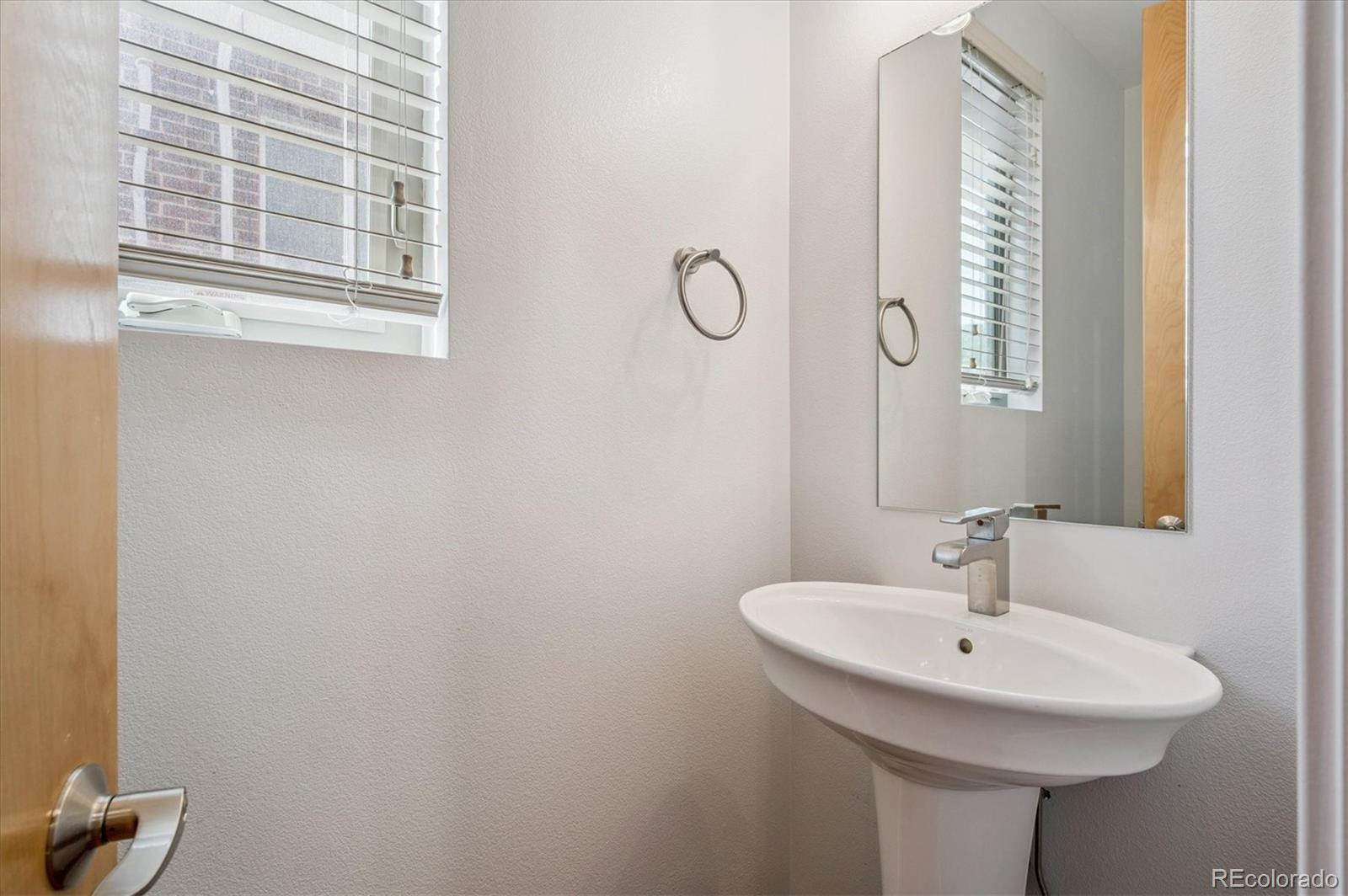 2157 South Logan Street Denver, CO 80210 - Photo 12 of 33 a bathroom with a sink and a mirror