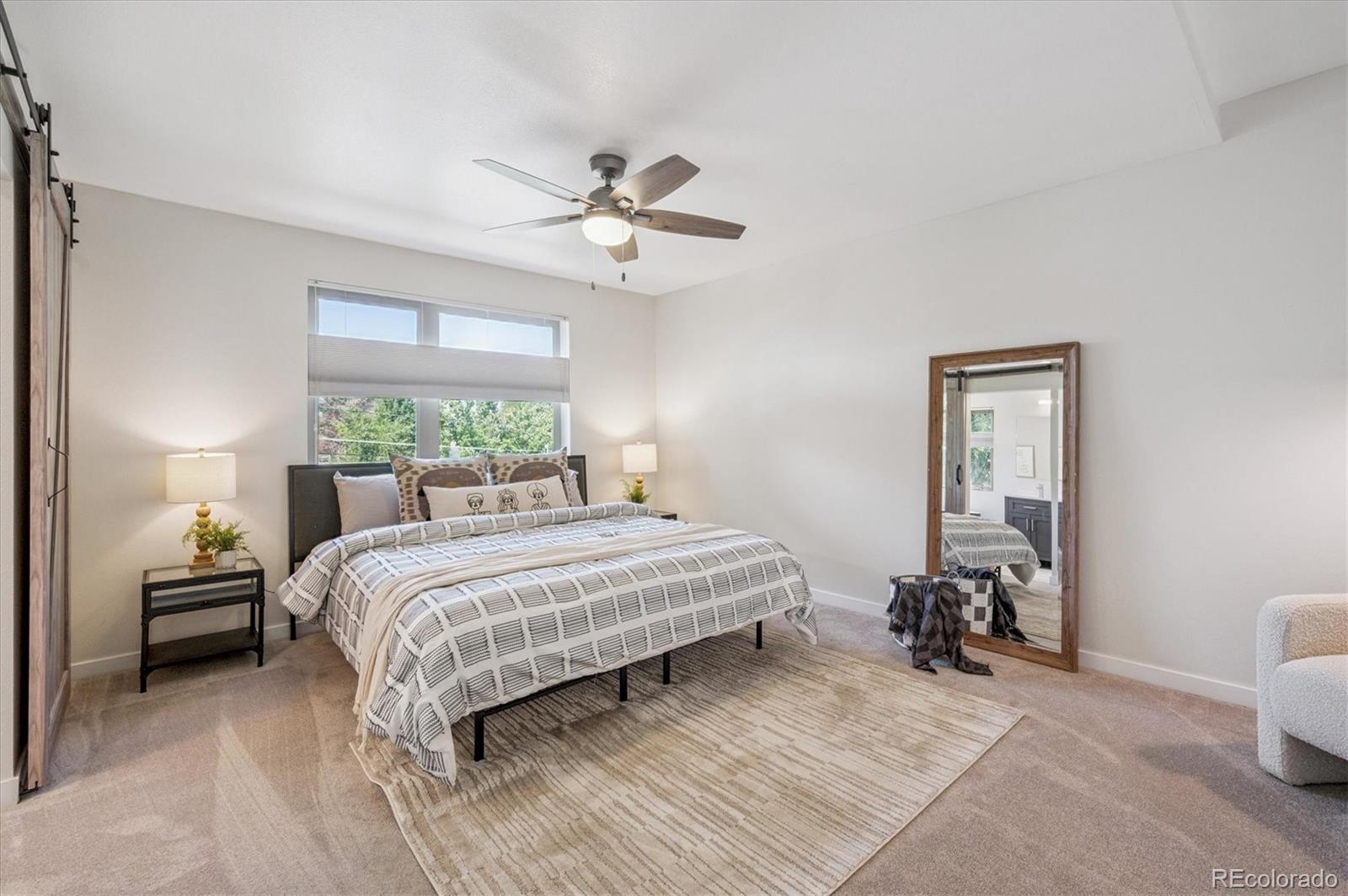 2157 South Logan Street Denver, CO 80210 - Photo 13 of 33 a bedroom with a bed and a chandelier