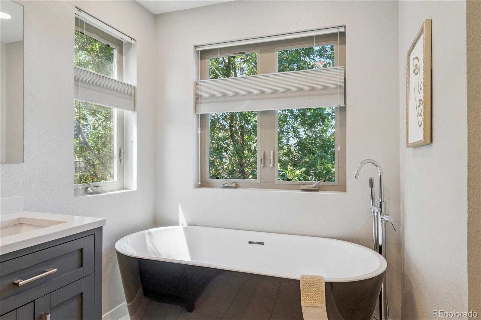 2157 South Logan Street Denver, CO 80210 - Photo 14 of 33 a bathroom with a tub sink and window