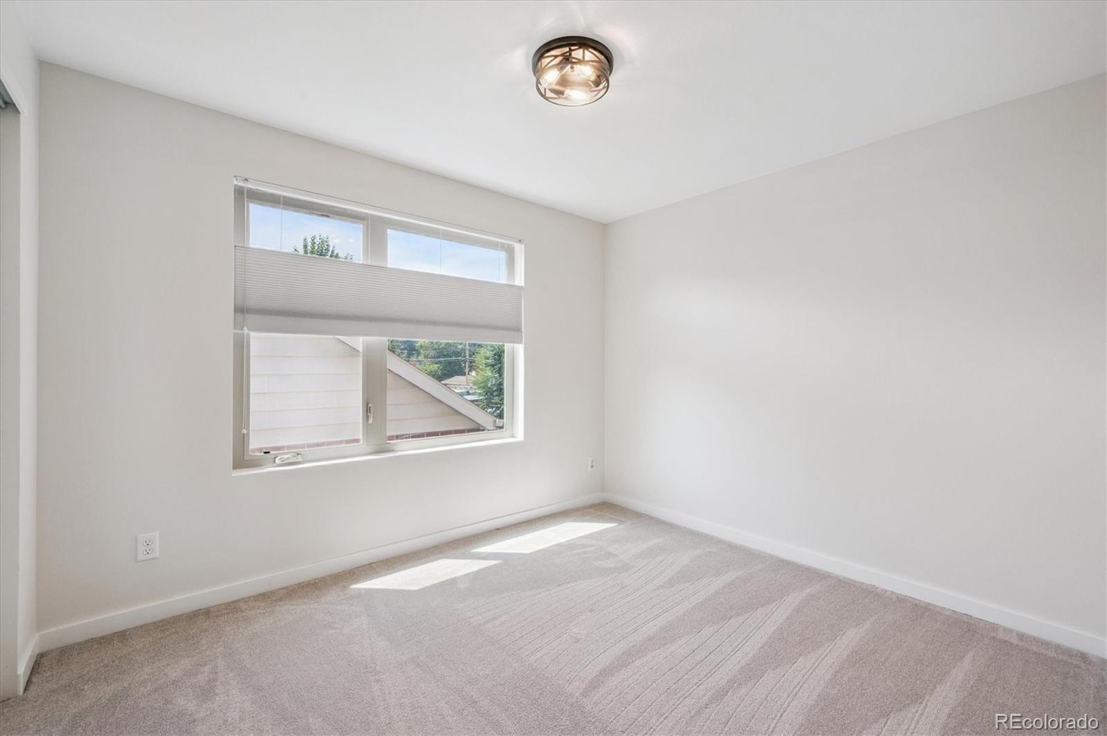 2157 South Logan Street Denver, CO 80210 - Photo 16 of 33 an empty room with a window