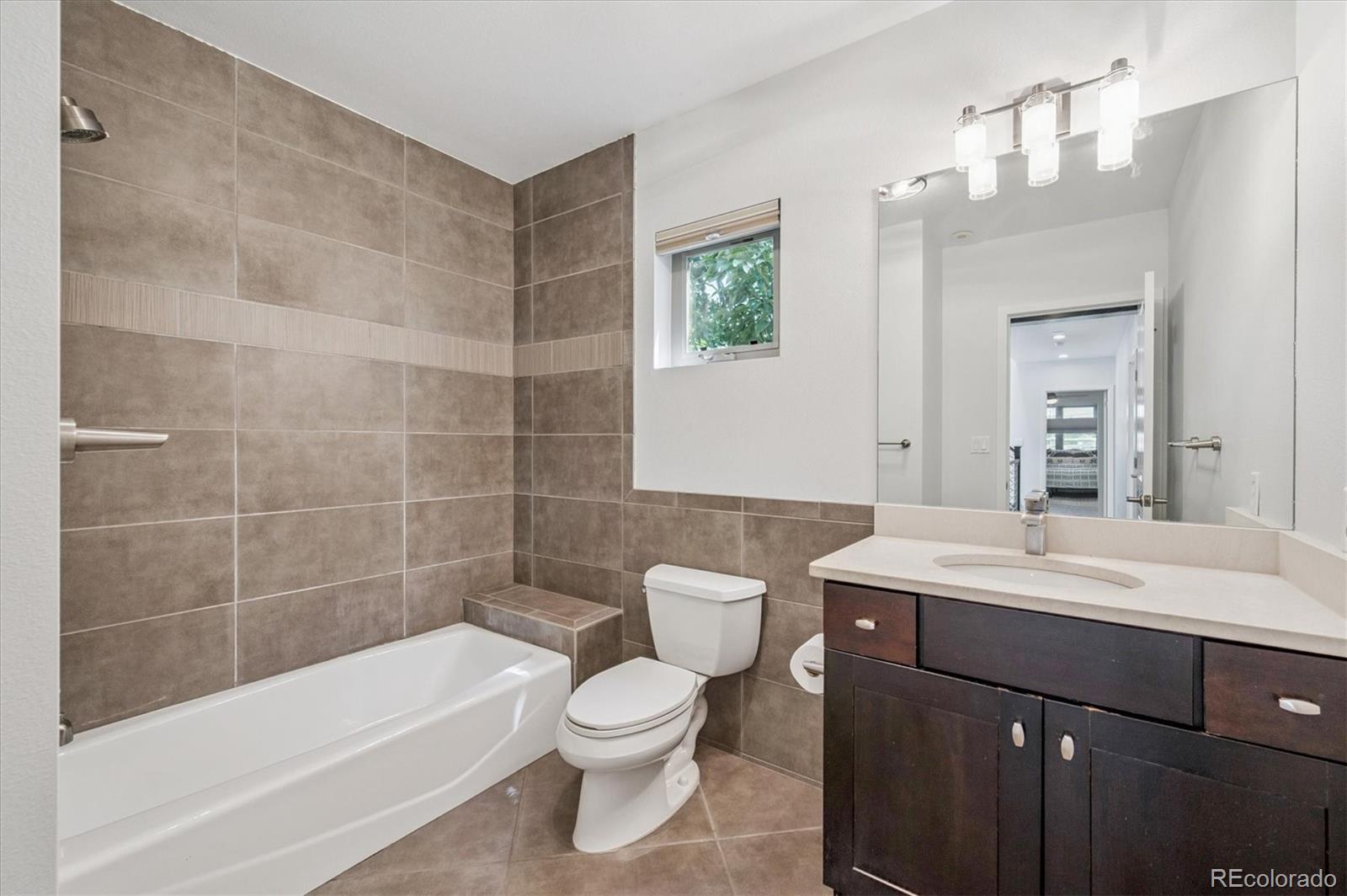 2157 South Logan Street Denver, CO 80210 - Photo 17 of 33 a bathroom with a sink a toilet and shower
