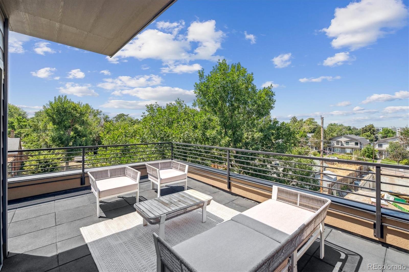 2157 South Logan Street Denver, CO 80210 - Photo 22 of 33 a view of a roof deck with couches and sky view