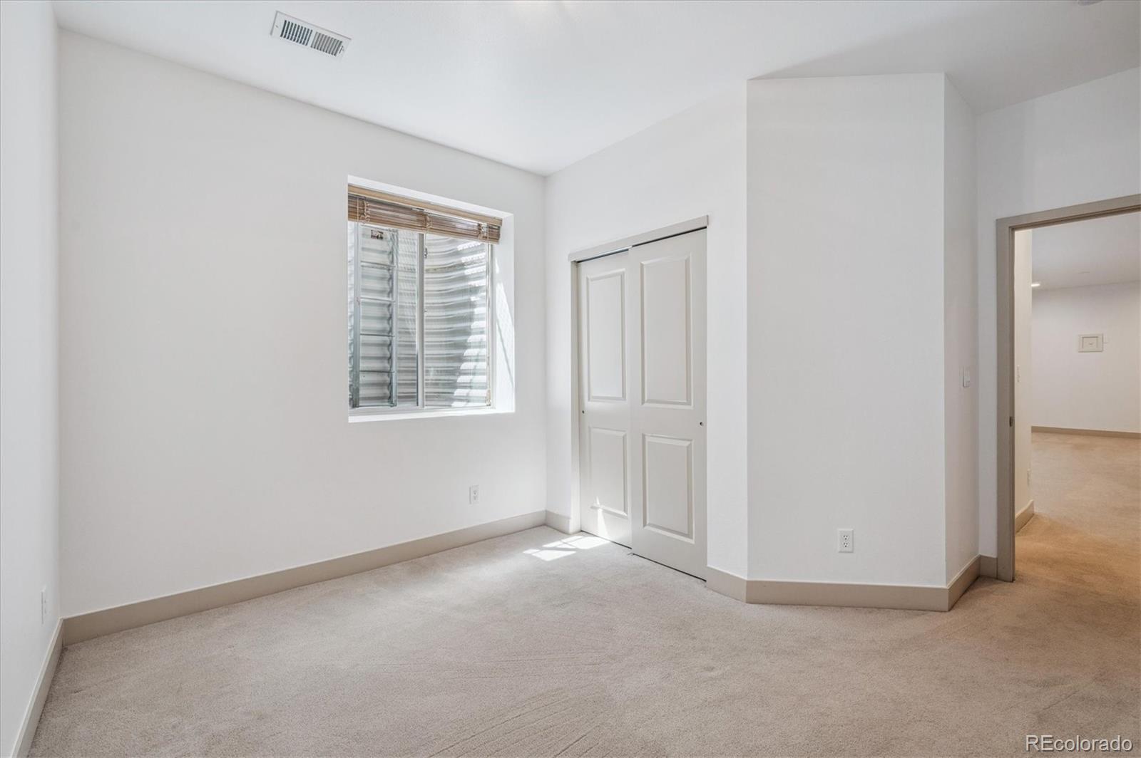 2157 South Logan Street Denver, CO 80210 - Photo 25 of 33 an empty room with windows