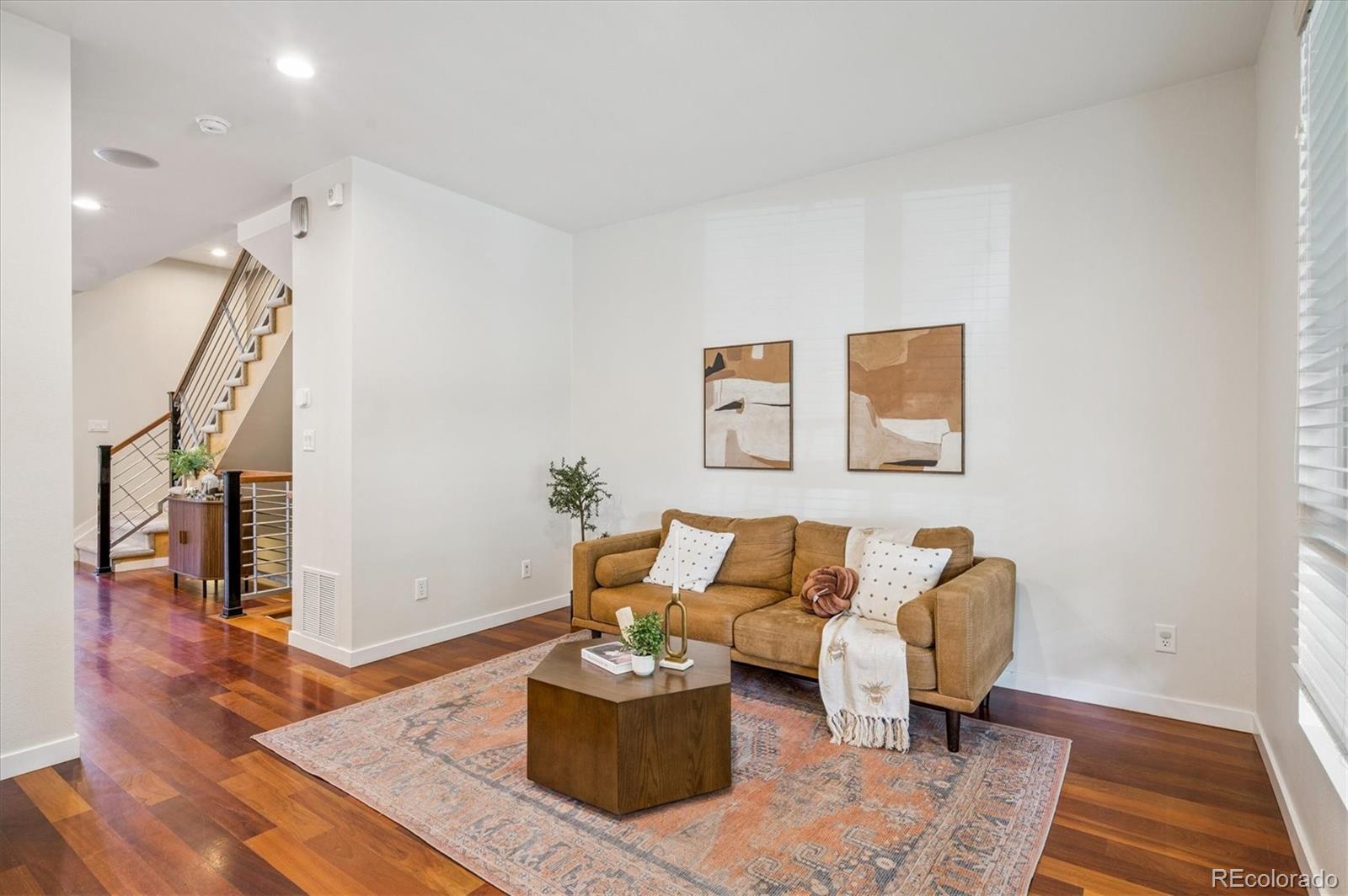2157 South Logan Street Denver, CO 80210 - Photo 3 of 33 a living room with furniture and wooden floor