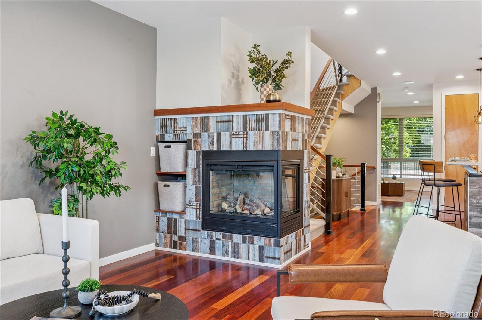 2157 South Logan Street Denver, CO 80210 - Photo 8 of 33 a living room with furniture a fireplace and a potted plant