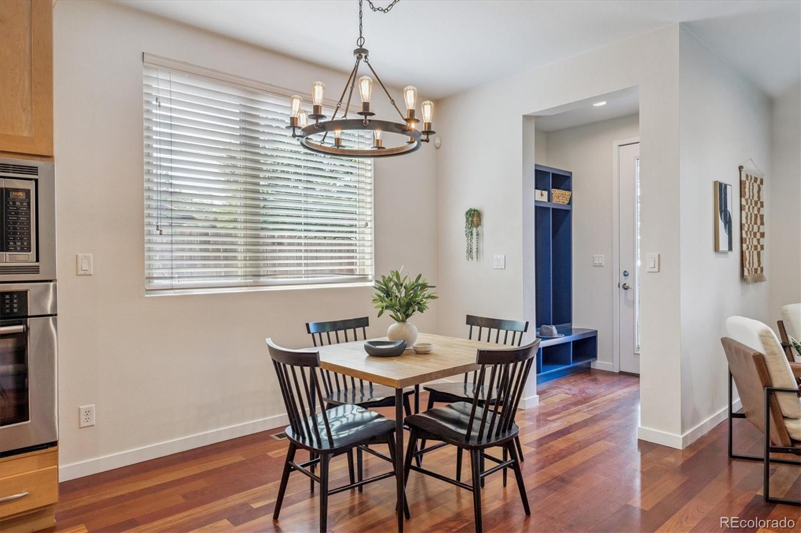 2157 South Logan Street Denver, CO 80210 - Photo 10 of 33 a view of a dining room with furniture wooden floor and chandelier