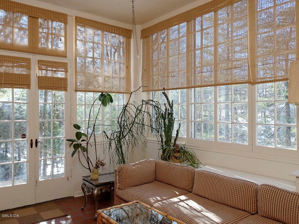 105 Dingletown Road Greenwich, CT 06830 - Photo 20 of 65 a living room with furniture and floor to ceiling windows