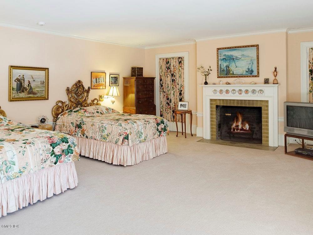 105 Dingletown Road Greenwich, CT 06830 - Photo 23 of 65 a bedroom with bed and a fireplace