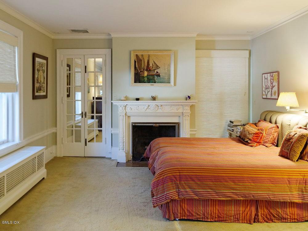 105 Dingletown Road Greenwich, CT 06830 - Photo 26 of 65 a bedroom with a bed and a fireplace